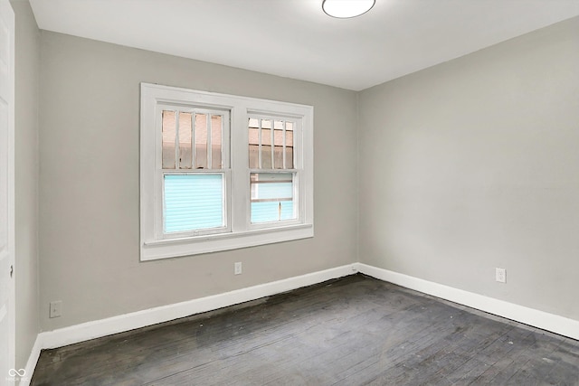 1033 N Dearborn St, Indianapolis, IN 46201 - empty room featuring baseboards and dark wood finished floors