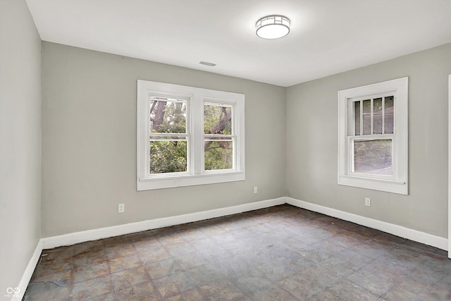 1033 N Dearborn St, Indianapolis, IN 46201 - spare room featuring baseboards and stone finish flooring