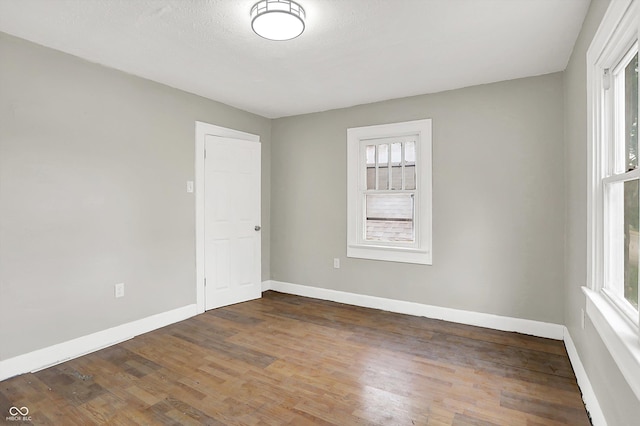 1033 N Dearborn St, Indianapolis, IN 46201 - unfurnished room with healthy amount of natural light, wood finished floors, and baseboards