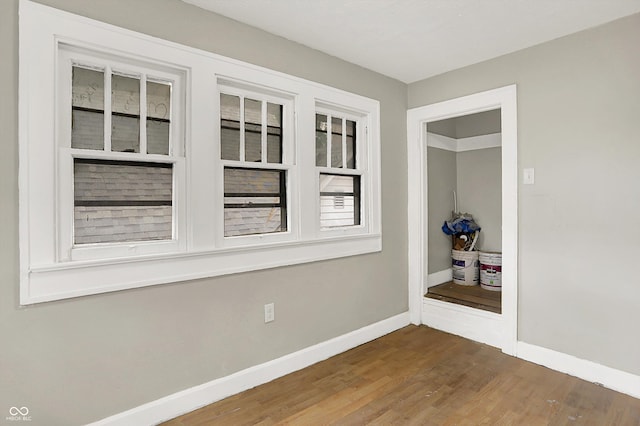 1033 N Dearborn St, Indianapolis, IN 46201 - spare room featuring baseboards and wood finished floors