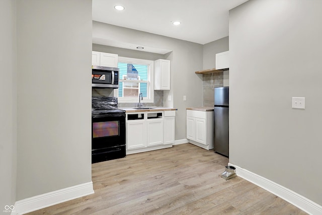 1033 N Dearborn St, Indianapolis, IN 46201 - kitchen with stainless steel appliances, white cabinetry, light wood-type flooring, baseboards, and light countertops