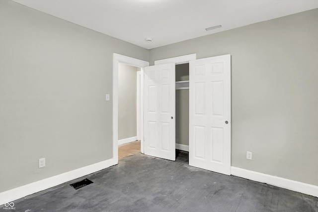 1033 N Dearborn St, Indianapolis, IN 46201 - unfurnished bedroom with baseboards, a closet, and wood finished floors