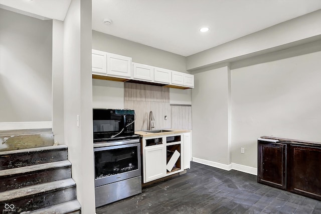 1033 N Dearborn St, Indianapolis, IN 46201 - kitchen with a sink, white cabinets, baseboards, light countertops, and black microwave