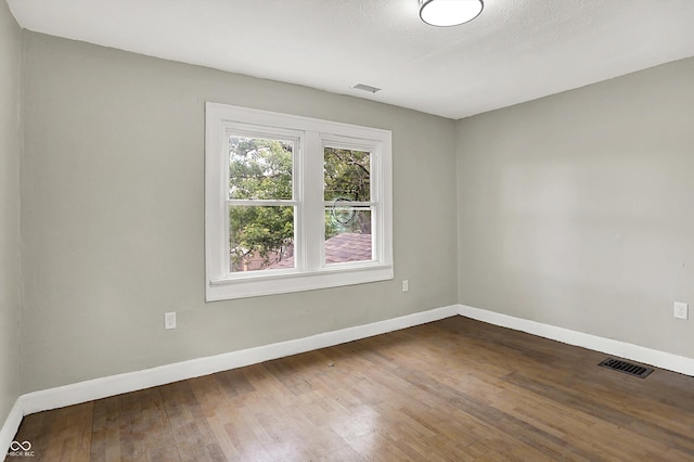 1033 N Dearborn St, Indianapolis, IN 46201 - unfurnished room with dark wood-type flooring and baseboards