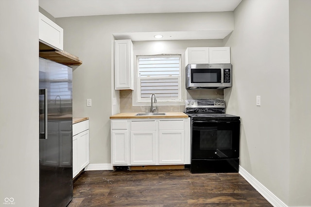 1033 N Dearborn St, Indianapolis, IN 46201 - kitchen featuring appliances with stainless steel finishes, a sink, dark wood-type flooring, white cabinets, and recessed lighting