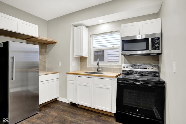 1033 N Dearborn St, Indianapolis, IN 46201 - kitchen featuring appliances with stainless steel finishes, a sink, wood counters, dark wood-style flooring, and white cabinets