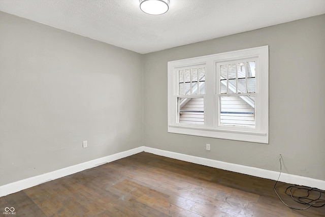 1033 N Dearborn St, Indianapolis, IN 46201 - spare room featuring dark wood finished floors, baseboards, and a textured ceiling