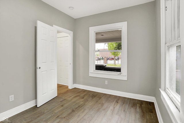 1033 N Dearborn St, Indianapolis, IN 46201 - spare room featuring baseboards, wood finished floors, and a smoke detector