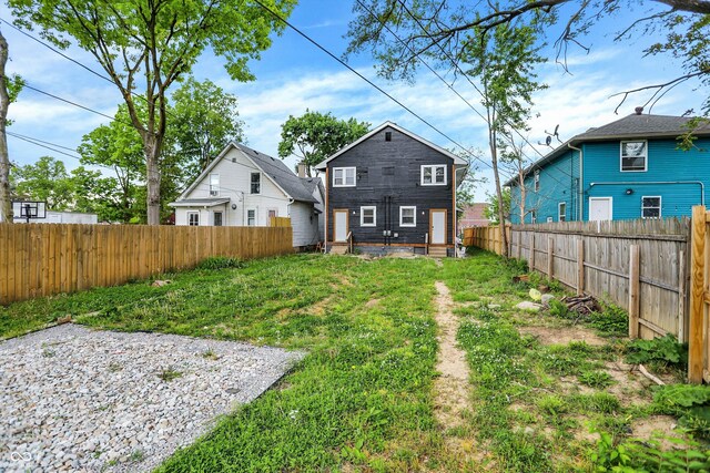 1033 N Dearborn St, Indianapolis, IN 46201 - rear view of property with a fenced backyard and entry steps