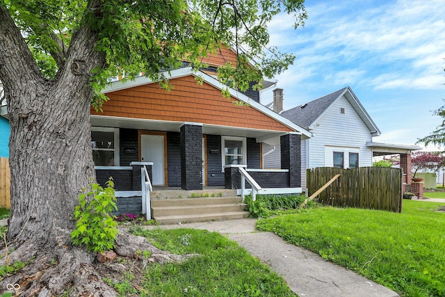 1033 N Dearborn St, Indianapolis, IN 46201 - view of front of home featuring fence and covered porch