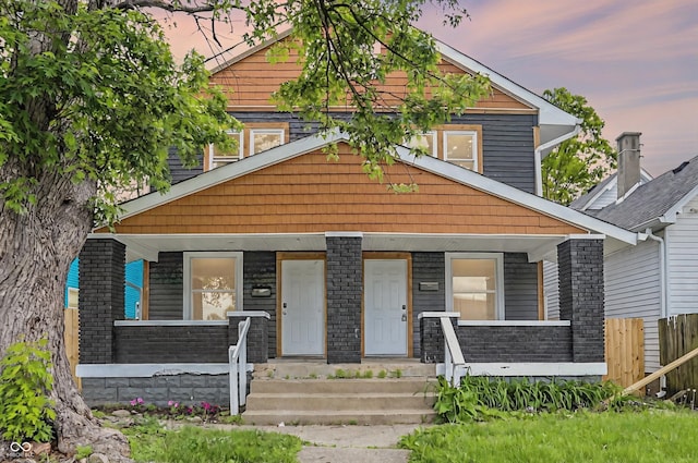 1033 N Dearborn St, Indianapolis, IN 46201 - view of front of house featuring a porch and fence