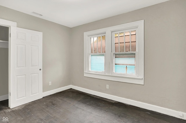 1033 N Dearborn St, Indianapolis, IN 46201 - unfurnished bedroom with dark wood-type flooring and baseboards