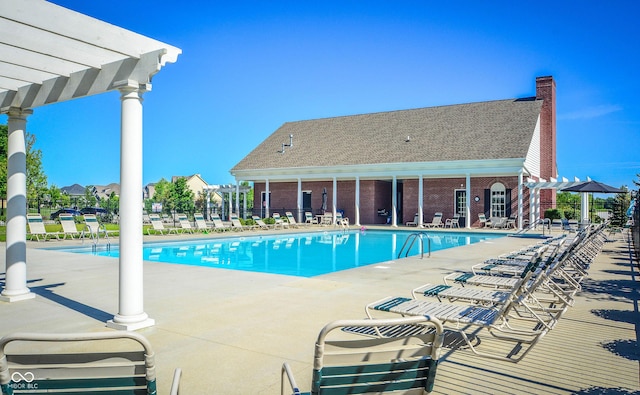 community pool with a pergola, a patio, and fence