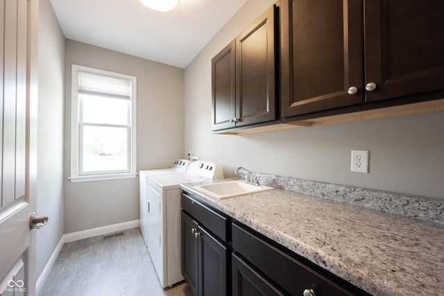 laundry room featuring cabinet space, independent washer and dryer, and baseboards