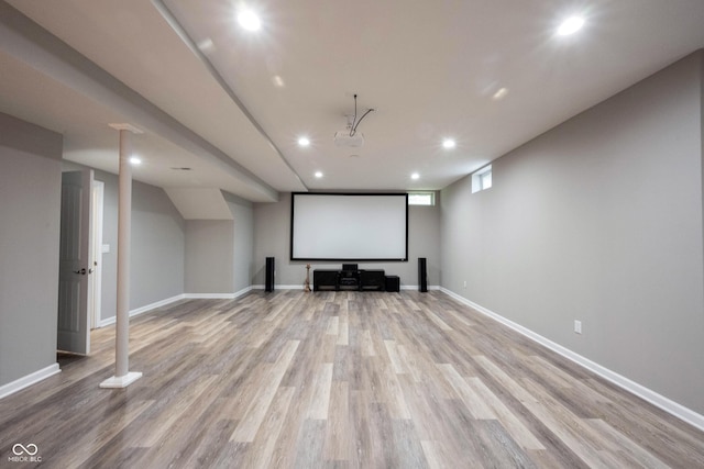 cinema room featuring wood finished floors, recessed lighting, and baseboards