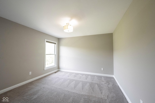 empty room with carpet floors and baseboards