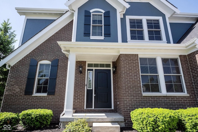 property entrance featuring brick siding