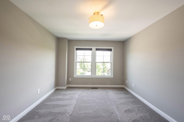 spare room with carpet and baseboards