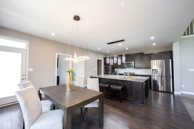 dining room featuring dark wood-style floors, baseboards, and recessed lighting