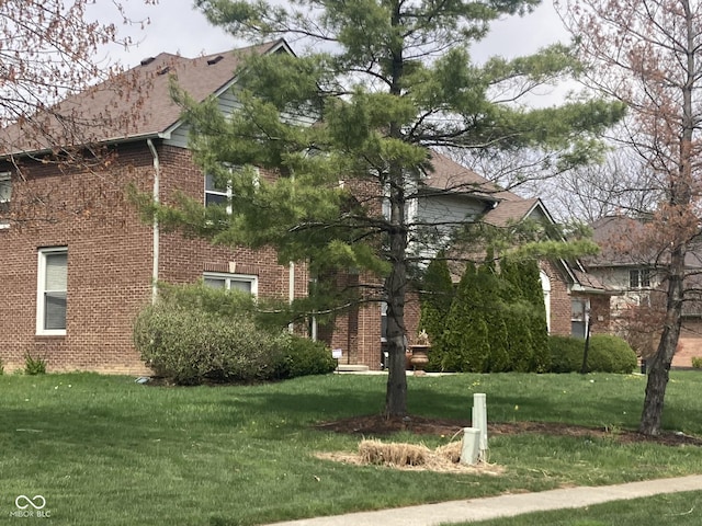 11458 Sutton Place Dr W, Carmel, IN 46032 - view of side of property with a lawn and brick siding