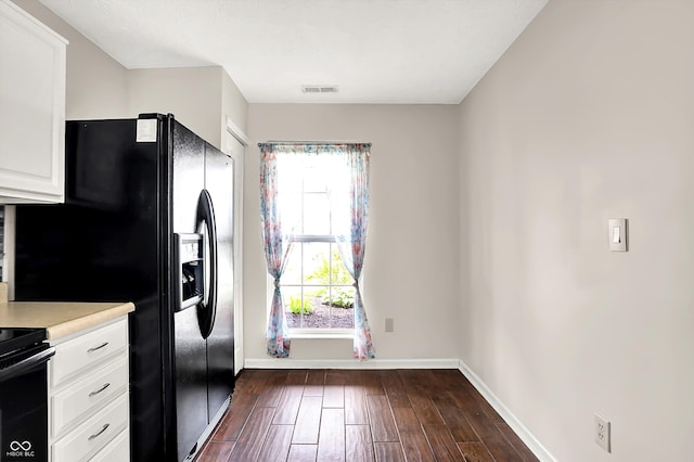 2201 Schoolmarm Dr, Greenfield, IN 46140 - kitchen with baseboards, white cabinetry, dark wood-style floors, light countertops, and black refrigerator with ice dispenser