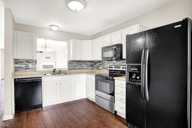 2201 Schoolmarm Dr, Greenfield, IN 46140 - kitchen featuring black appliances, a sink, decorative backsplash, light countertops, and dark wood finished floors