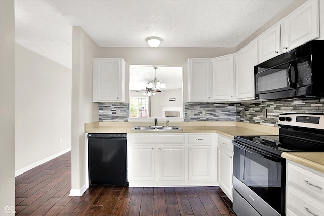2201 Schoolmarm Dr, Greenfield, IN 46140 - kitchen with black appliances, a sink, a chandelier, decorative backsplash, and light countertops