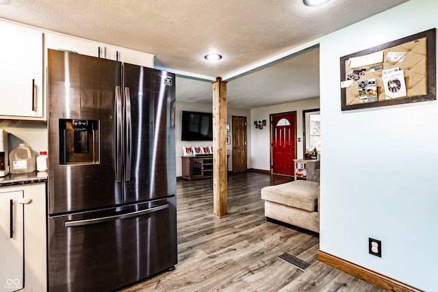 2965 E 1100 N, Pendleton, IN 46064 - kitchen featuring stainless steel refrigerator with ice dispenser, baseboards, white cabinetry, light wood finished floors, and a textured ceiling