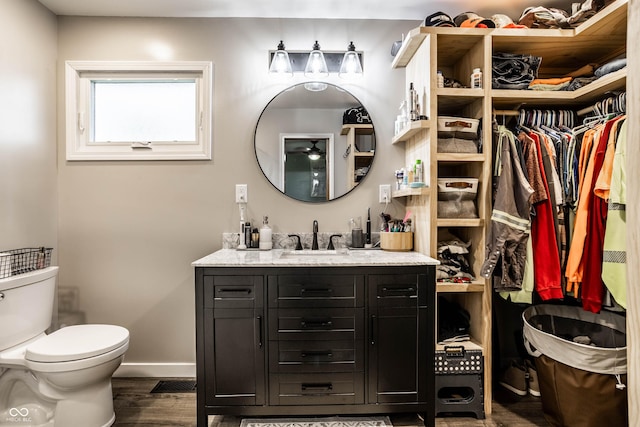 2965 E 1100 N, Pendleton, IN 46064 - bathroom featuring wood finished floors, toilet, vanity, baseboards, and a spacious closet