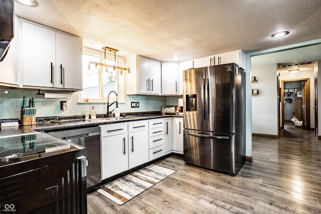 2965 E 1100 N, Pendleton, IN 46064 - kitchen featuring appliances with stainless steel finishes, a sink, a textured ceiling, dark countertops, and wood finished floors