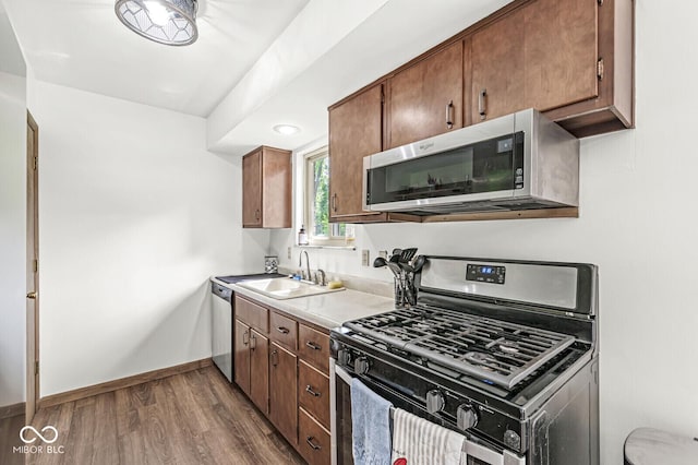 5427 Heights Ave, Indianapolis, IN 46237 - kitchen featuring appliances with stainless steel finishes, a sink, dark wood-type flooring, light countertops, and baseboards