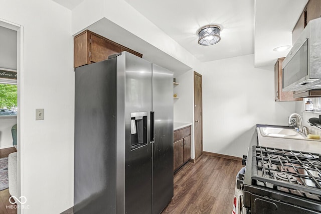5427 Heights Ave, Indianapolis, IN 46237 - kitchen featuring appliances with stainless steel finishes, dark wood-type flooring, a sink, baseboards, and light countertops