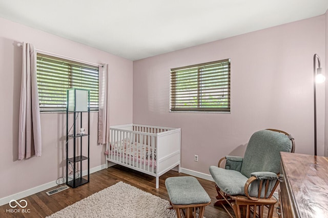5427 Heights Ave, Indianapolis, IN 46237 - bedroom featuring wood finished floors, baseboards, and a crib