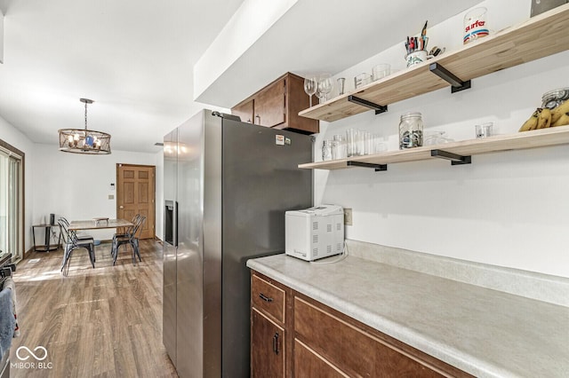 5427 Heights Ave, Indianapolis, IN 46237 - kitchen with wood finished floors, open shelves, light countertops, a chandelier, and stainless steel fridge