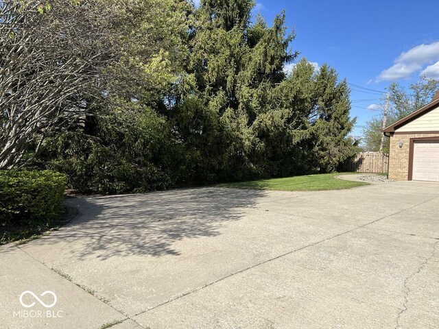 6143 Roberts Pl, Indianapolis, IN 46220 - view of yard featuring concrete driveway