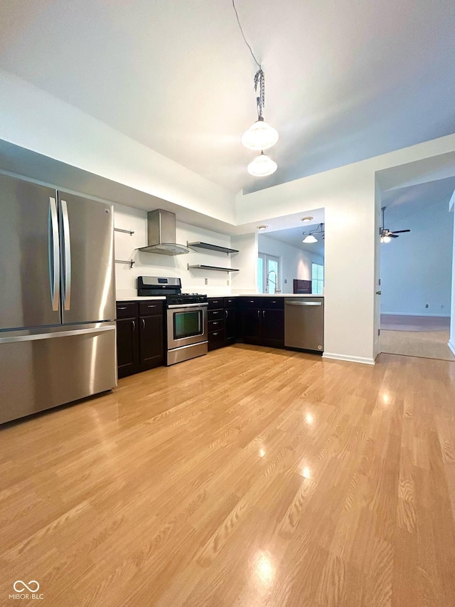 6143 Roberts Pl, Indianapolis, IN 46220 - kitchen featuring appliances with stainless steel finishes, wall chimney exhaust hood, open shelves, light wood-style flooring, and dark cabinets