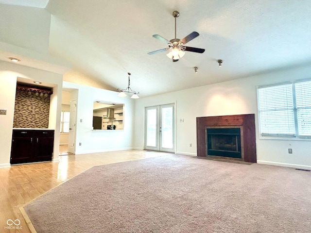 6143 Roberts Pl, Indianapolis, IN 46220 - unfurnished living room with vaulted ceiling, a fireplace with flush hearth, a ceiling fan, baseboards, and wood finished floors