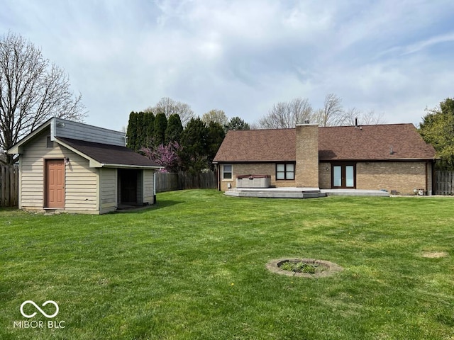 6143 Roberts Pl, Indianapolis, IN 46220 - rear view of house with a chimney, an outbuilding, a shed, and brick siding