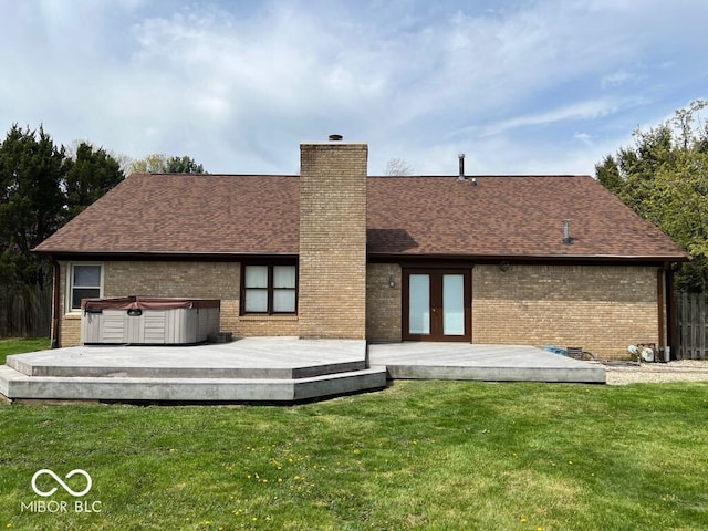 6143 Roberts Pl, Indianapolis, IN 46220 - rear view of property featuring a hot tub, brick siding, a deck, a chimney, and a shingled roof