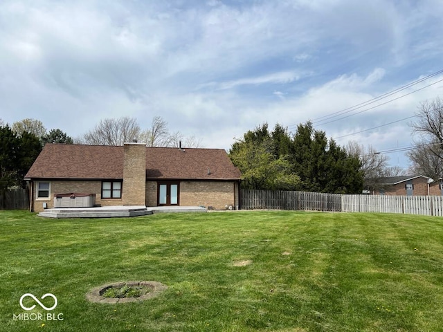 6143 Roberts Pl, Indianapolis, IN 46220 - back of house featuring brick siding, a chimney, and french doors