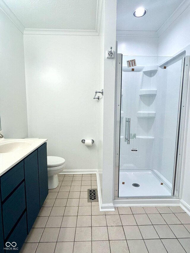 6143 Roberts Pl, Indianapolis, IN 46220 - full bathroom featuring crown molding, a shower stall, tile patterned floors, toilet, and vanity