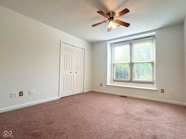 6143 Roberts Pl, Indianapolis, IN 46220 - unfurnished bedroom featuring a textured ceiling, baseboards, carpet flooring, a closet, and a ceiling fan