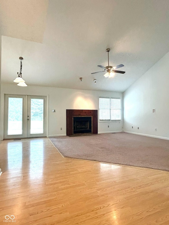 6143 Roberts Pl, Indianapolis, IN 46220 - unfurnished living room with baseboards, a ceiling fan, light wood-style floors, a fireplace, and lofted ceiling