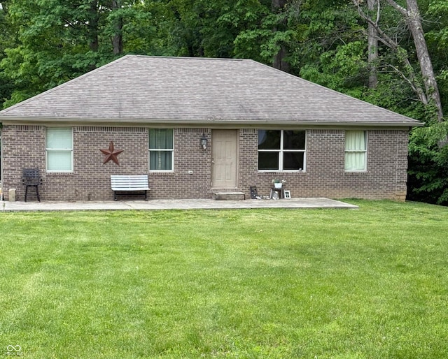 8701 Squires Dr, Paragon, IN 46166 - view of front of house featuring roof with shingles, brick siding, and a front lawn