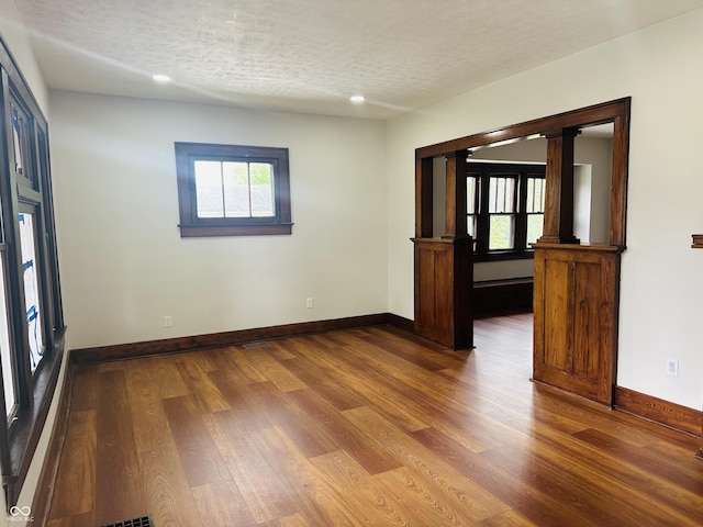 1718 Thaddeus St, Indianapolis, IN 46203 - empty room featuring a textured ceiling, wood finished floors, baseboards, and recessed lighting