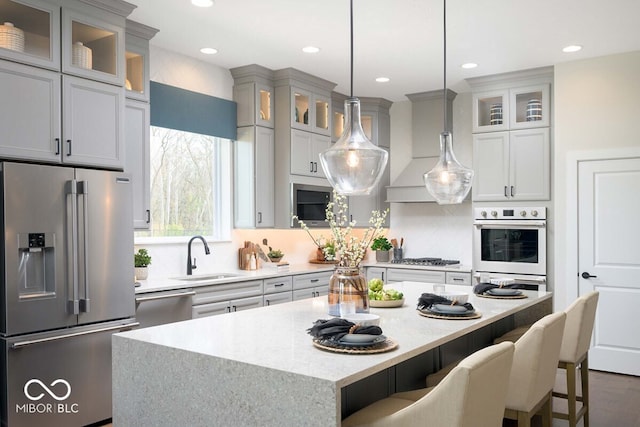19848 Chatsworth Blvd, Westfield, IN 46074 - kitchen featuring stainless steel appliances, a sink, a center island, pendant lighting, and a kitchen breakfast bar