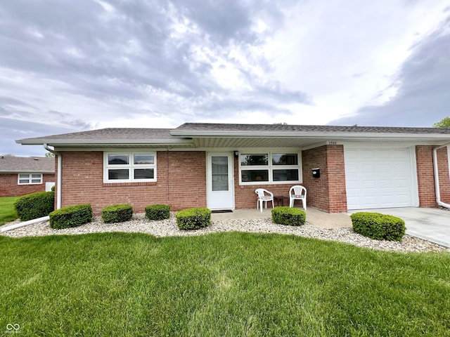 2508 Pamela Ct, Anderson, IN 46012 - ranch-style house with a front yard, a garage, brick siding, and driveway