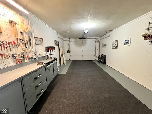 2508 Pamela Ct, Anderson, IN 46012 - garage with a garage door opener and a workshop area