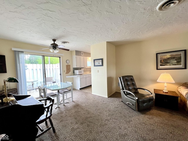 2508 Pamela Ct, Anderson, IN 46012 - living area with light colored carpet, ceiling fan, a textured ceiling, and baseboards
