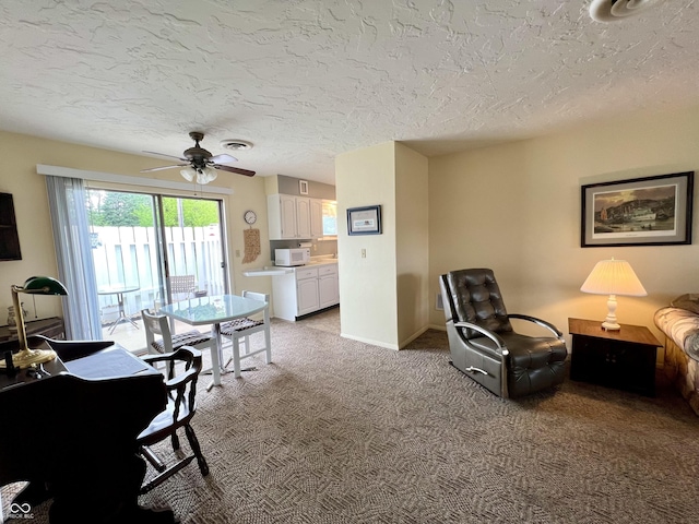 2508 Pamela Ct, Anderson, IN 46012 - living area featuring light carpet, ceiling fan, a textured ceiling, and baseboards
